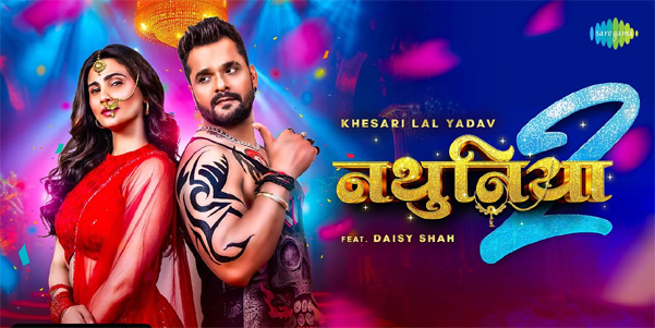 Khesari Lal Yadav and Daisy Shah dancing in vibrant traditional attire in the Nathuniya 2 music video.