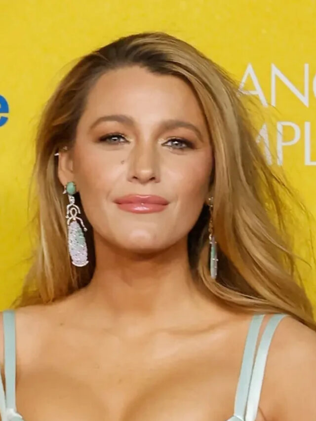 Blake Lively and Ryan Reynolds smile together at a public event.